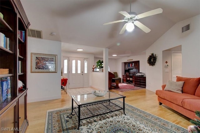 living room with ceiling fan, light hardwood / wood-style flooring, and vaulted ceiling