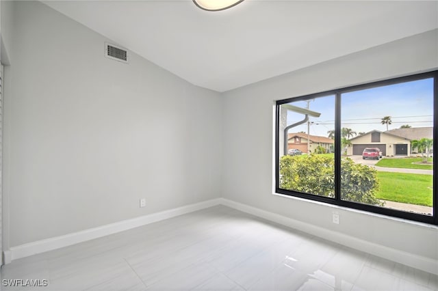 unfurnished room with vaulted ceiling