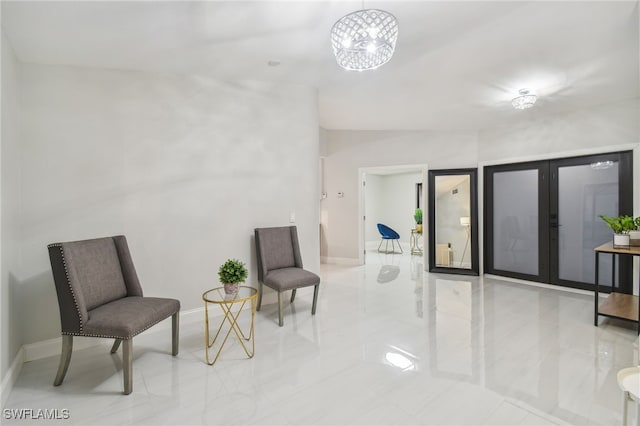 sitting room featuring a chandelier