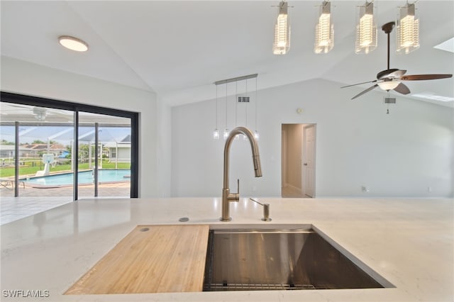 kitchen featuring decorative light fixtures, vaulted ceiling, and ceiling fan