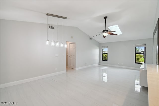 spare room with lofted ceiling with skylight and ceiling fan