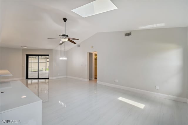 unfurnished room featuring ceiling fan and lofted ceiling with skylight