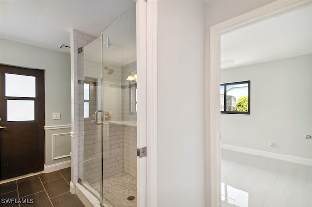 bathroom with a shower with door