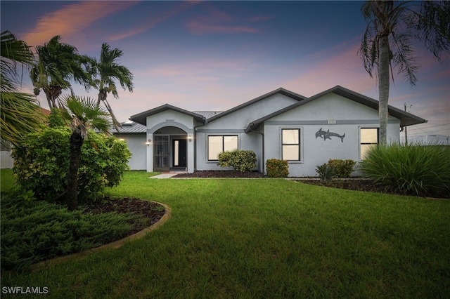 ranch-style house featuring a lawn