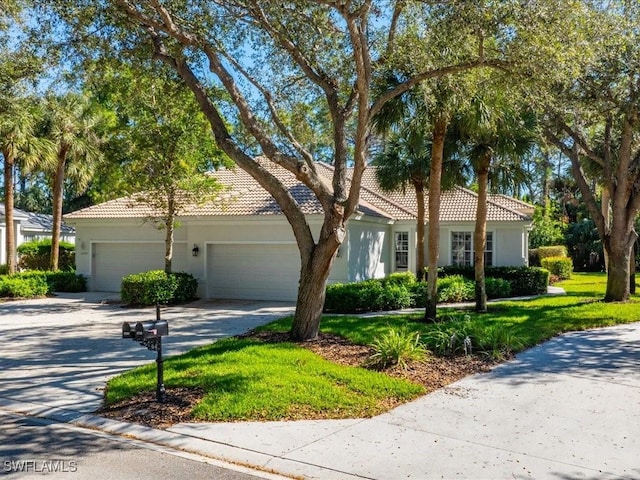 view of front of property featuring a garage and a front yard