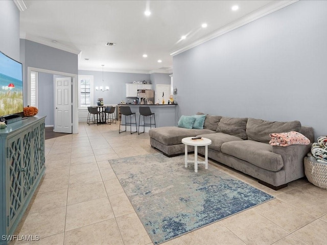 tiled living room featuring crown molding and an inviting chandelier