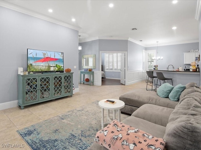 living room with light tile patterned flooring, ornamental molding, and a notable chandelier