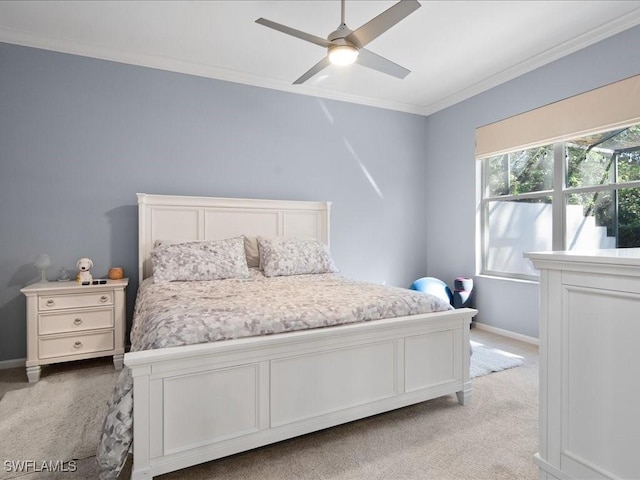 carpeted bedroom featuring crown molding and ceiling fan