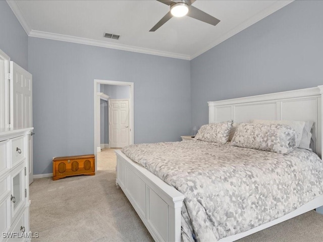 carpeted bedroom with ornamental molding and ceiling fan