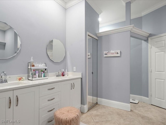 bathroom with tile patterned flooring, ornamental molding, and vanity