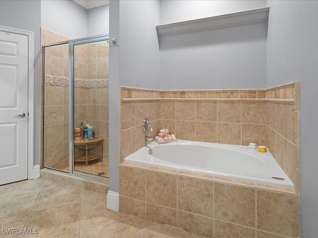 bathroom with tile patterned floors and shower with separate bathtub