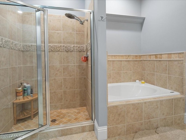 bathroom featuring shower with separate bathtub