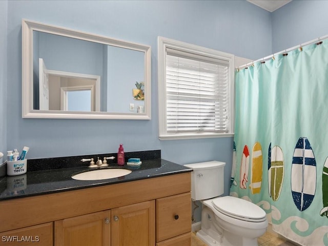 bathroom featuring vanity, tile patterned floors, and toilet