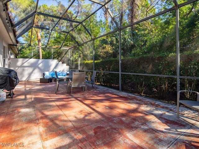 view of patio / terrace with a lanai and a grill