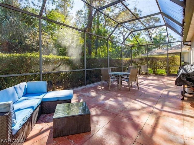 view of patio with outdoor lounge area and glass enclosure