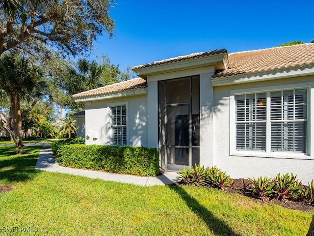 doorway to property with a yard