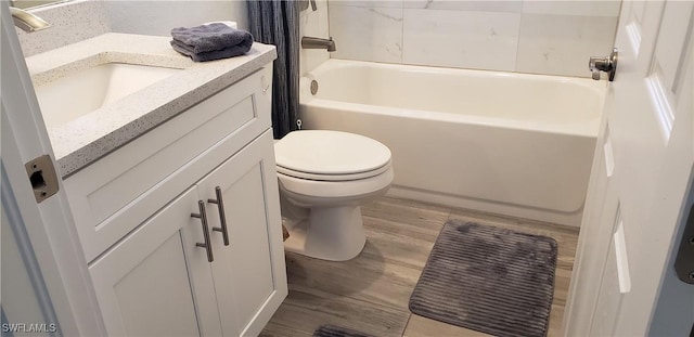 full bathroom featuring vanity, toilet, wood-type flooring, and tub / shower combination