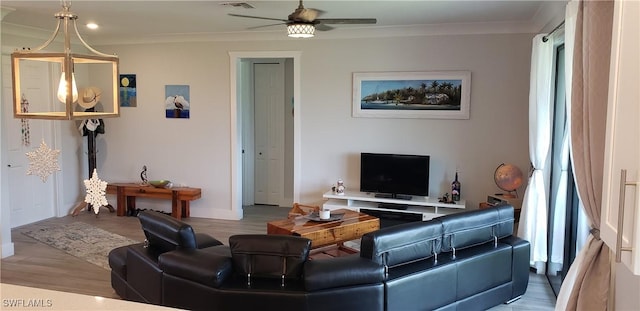 living room with ceiling fan, crown molding, and light hardwood / wood-style flooring