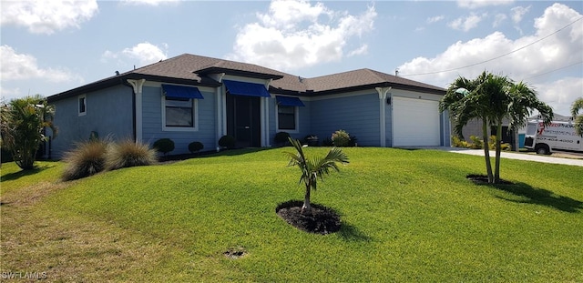 view of front facade with a front yard and a garage