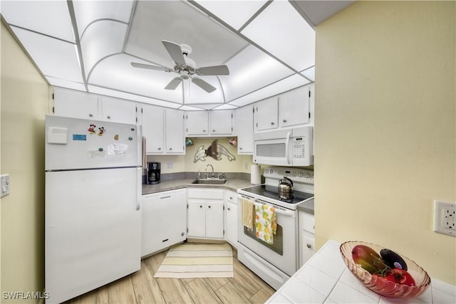 kitchen with white appliances, ceiling fan, sink, light hardwood / wood-style flooring, and white cabinets