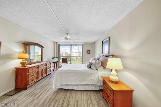 bedroom with access to outside, ceiling fan, light hardwood / wood-style flooring, and a textured ceiling