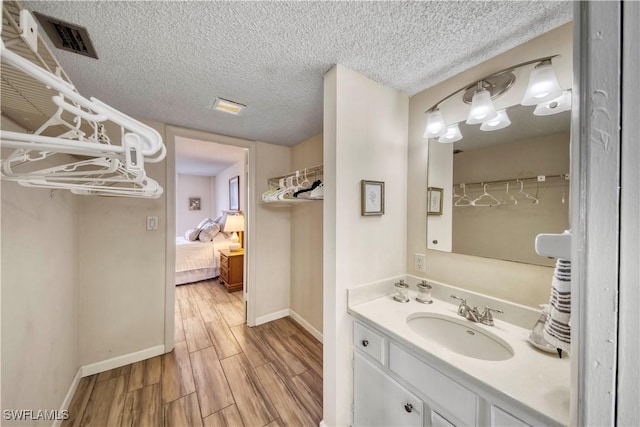 bathroom with vanity and a textured ceiling