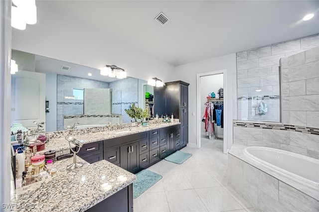 bathroom with tile patterned flooring, vanity, and shower with separate bathtub