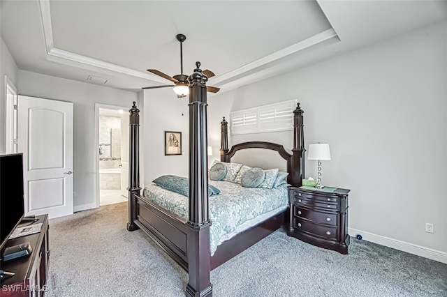 bedroom featuring carpet, ceiling fan, connected bathroom, and a tray ceiling