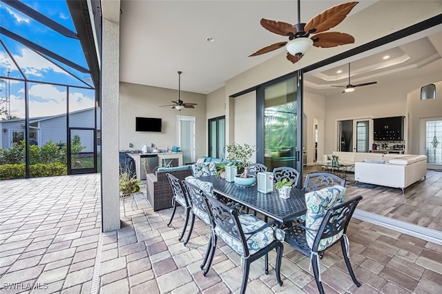 view of patio featuring an outdoor hangout area and glass enclosure