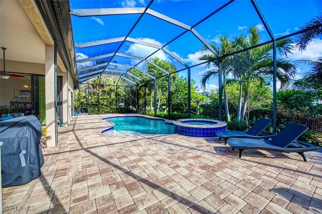 view of swimming pool featuring a patio area, a lanai, an in ground hot tub, and grilling area