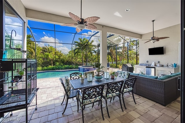 view of patio with a grill, area for grilling, a lanai, and a swimming pool with hot tub