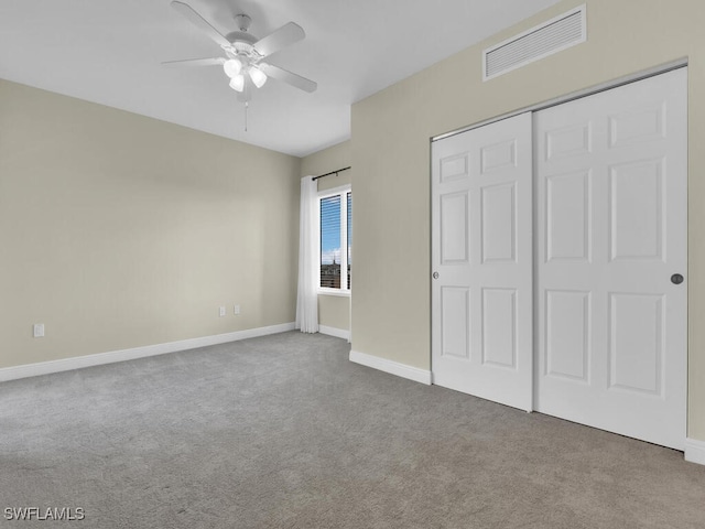 unfurnished bedroom featuring carpet floors, a closet, and ceiling fan