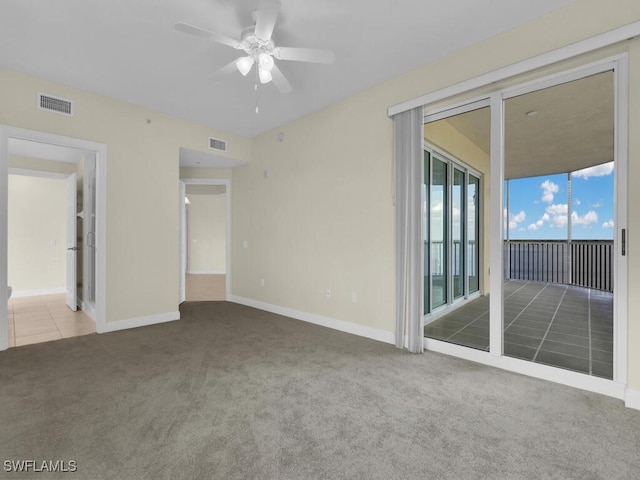 empty room featuring tile patterned floors and ceiling fan