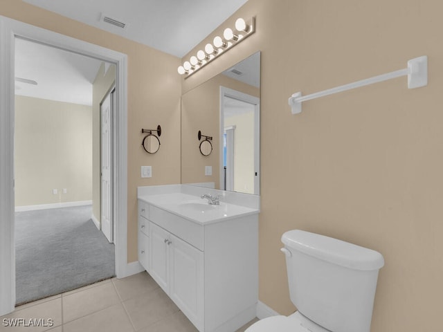 bathroom featuring tile patterned floors, vanity, and toilet