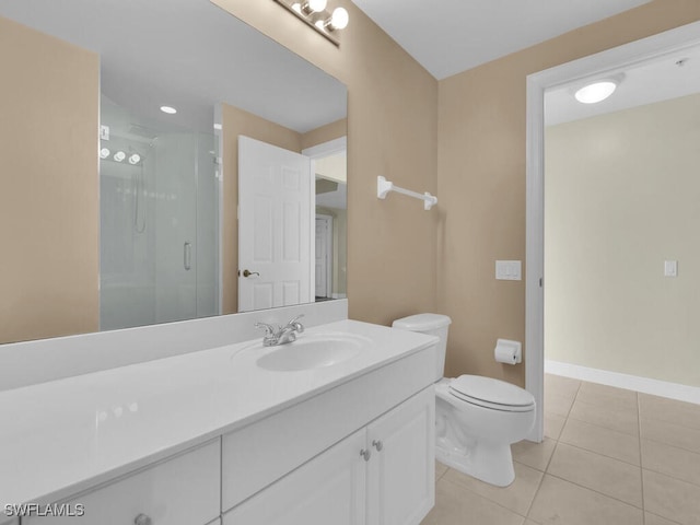 bathroom featuring tile patterned floors, vanity, a shower with shower door, and toilet