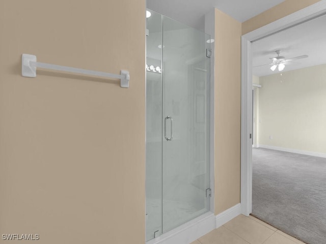 bathroom with tile patterned flooring, ceiling fan, and walk in shower