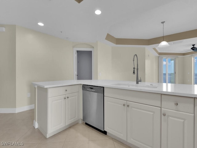 kitchen featuring stainless steel dishwasher, ceiling fan, sink, pendant lighting, and white cabinetry