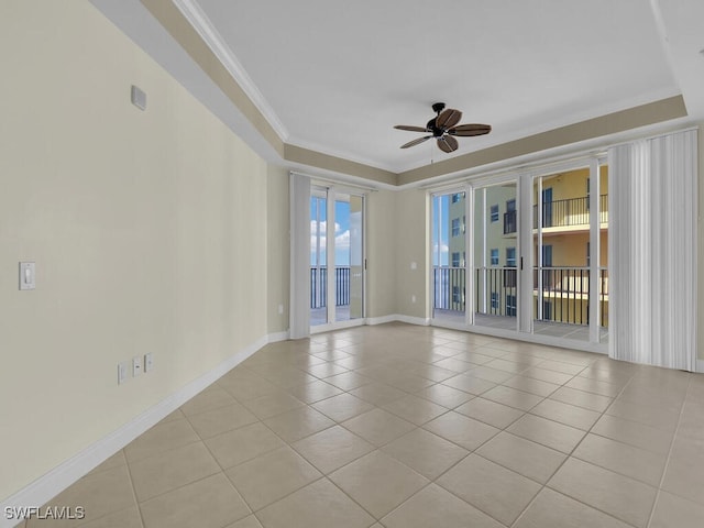 spare room with ceiling fan, crown molding, and light tile patterned floors