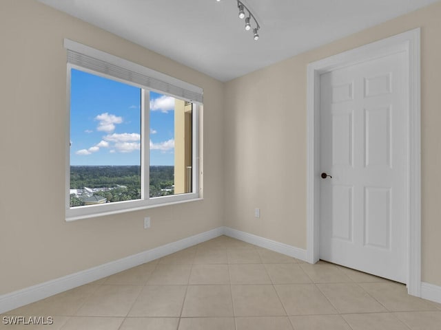 unfurnished room featuring light tile patterned floors