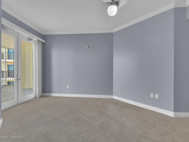 carpeted spare room with french doors, ceiling fan, and crown molding