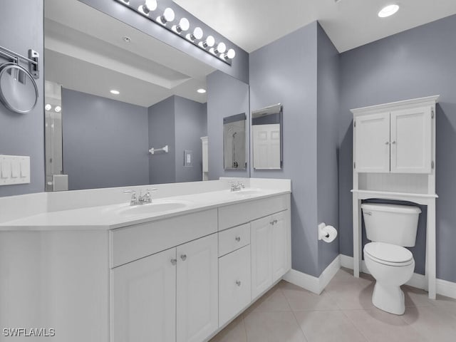 bathroom with tile patterned flooring, vanity, and toilet