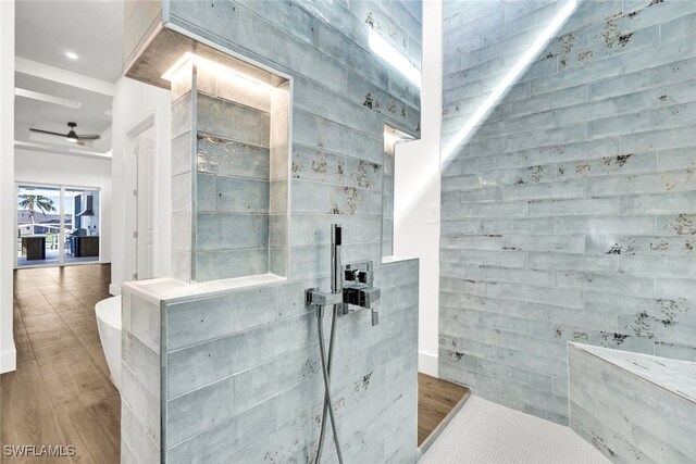 bathroom featuring ceiling fan, hardwood / wood-style flooring, and walk in shower