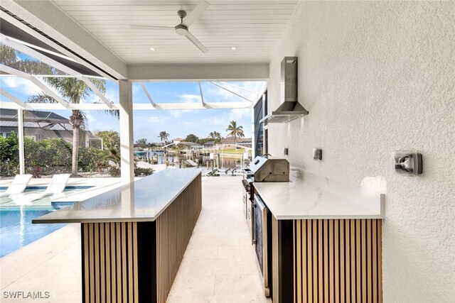 view of patio / terrace featuring glass enclosure, ceiling fan, and exterior bar