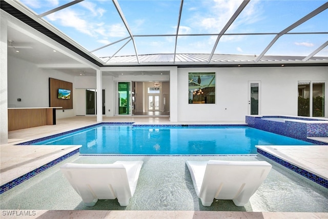 view of pool featuring a patio area, a lanai, and an in ground hot tub