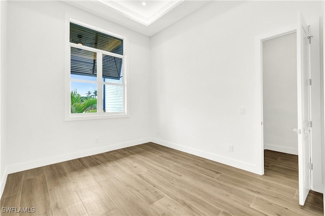 empty room with light wood-type flooring and baseboards