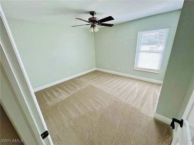 empty room featuring carpet flooring and ceiling fan