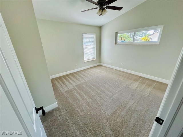 unfurnished room with a wealth of natural light, light carpet, ceiling fan, and vaulted ceiling