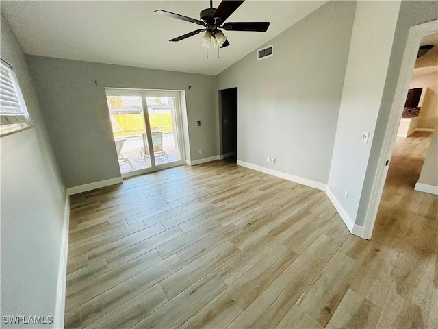 empty room featuring light hardwood / wood-style flooring, ceiling fan, and lofted ceiling