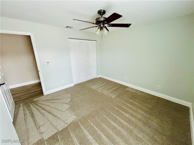 unfurnished bedroom featuring carpet flooring, ceiling fan, and a closet