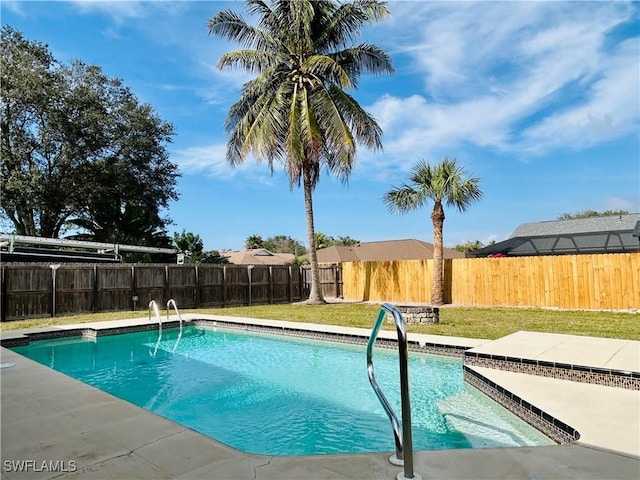 view of pool featuring a lawn